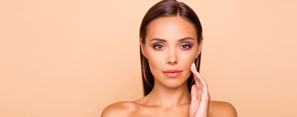 woman-touching-her-chin-showing-results-of-dermal-filler-injections